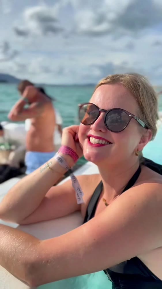 Jeanella smiling in sunglasses at YONA Beach Club